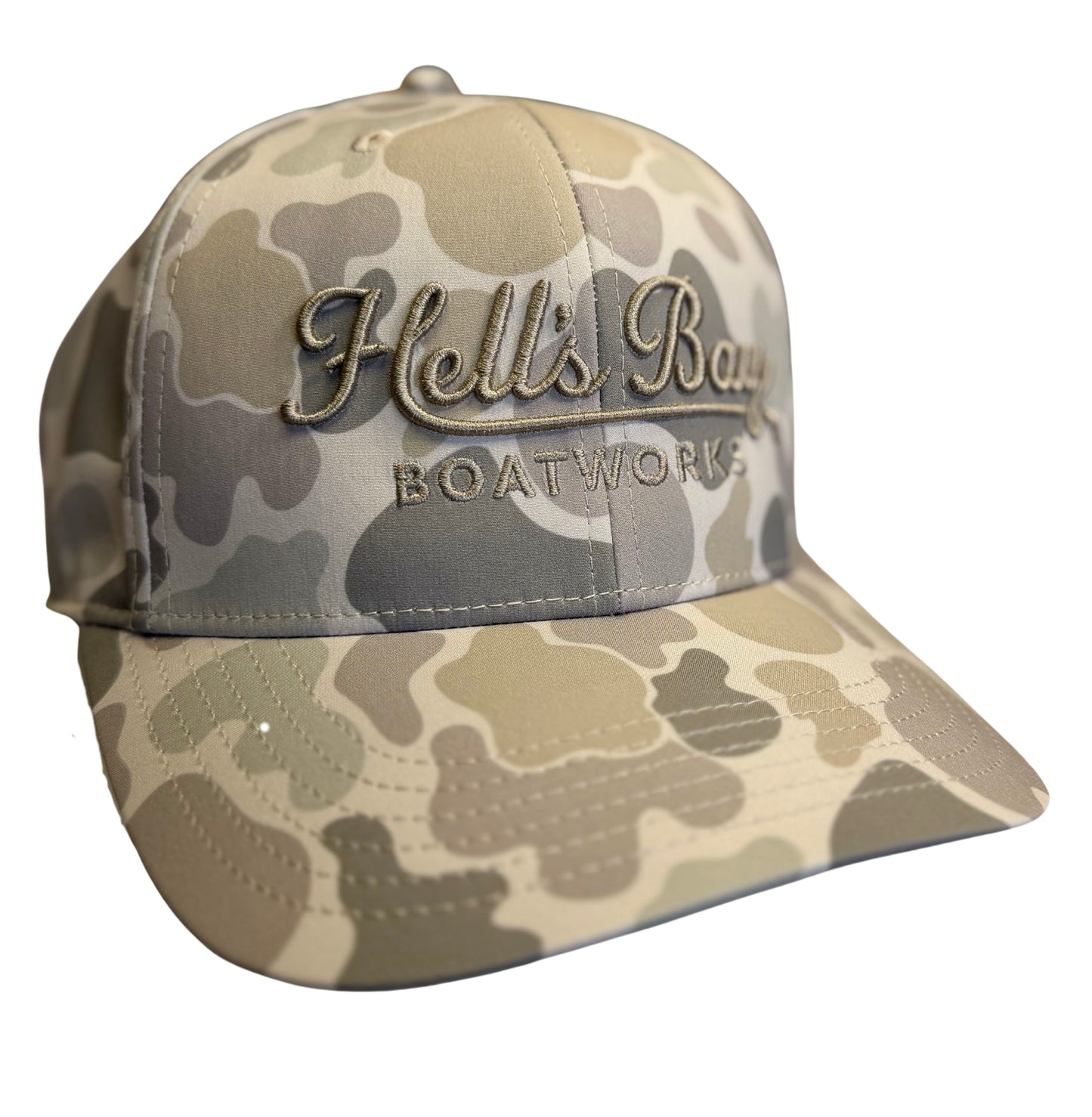 Camouflage baseball cap with 'Hell's Bay Boatworks' logo on a white background