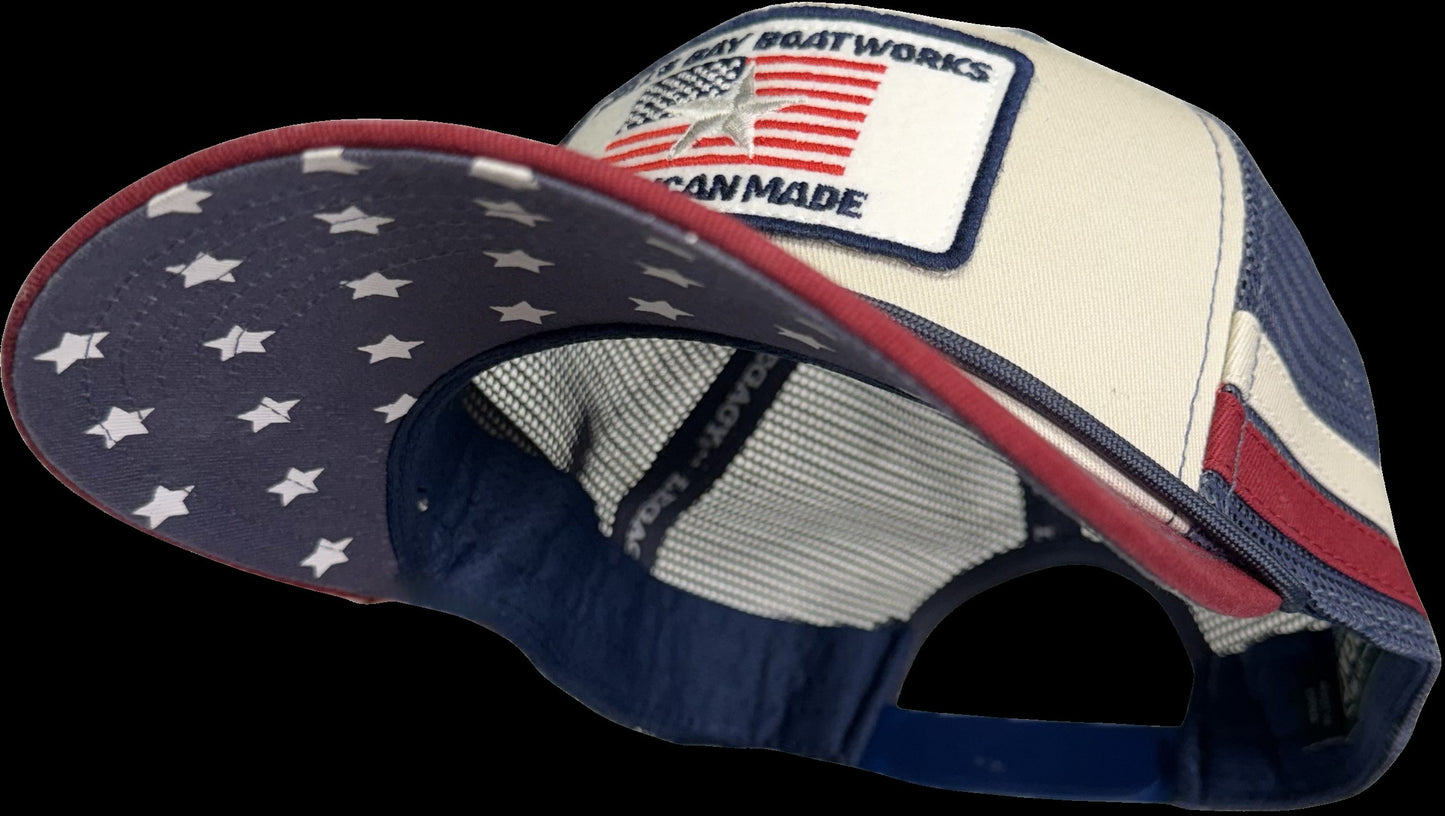 
                  
                    Cap with American flag design and 'American Made' patch on a black background
                  
                