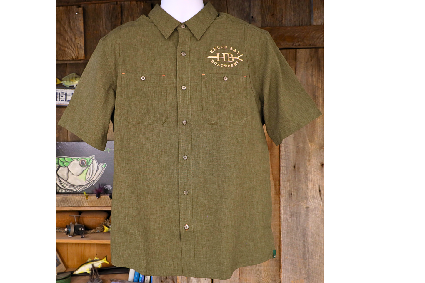 
                  
                    Green Hell’s Bay Orvis Tech Chambray short sleeve work shirt with button front, two chest pockets, and embroidered HB push pole logo.
                  
                